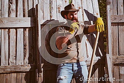 Cowboy portrait. Farmer planting in the vegetable garden. Agricultural Land. Stock Photo