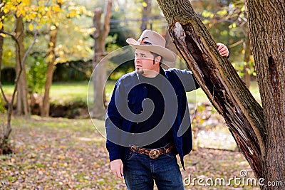 Cowboy Rancher at Tree looking to Left Stock Photo