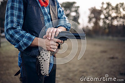 Cowboy with revolver makes quick shot, western Stock Photo