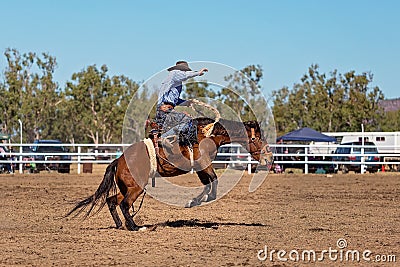 Cowboy Riding A Bucking Bronc Horse At A Country Rodeo Stock Photo