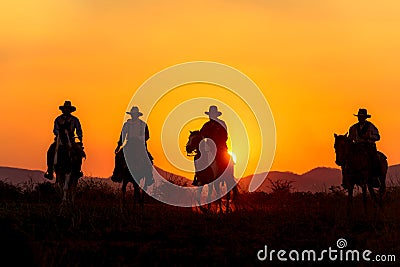 Cowboy silhouette riding a horse. Stock Photo