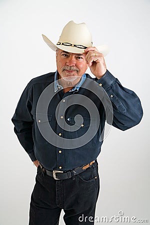 Cowboy tipping hat Stock Photo