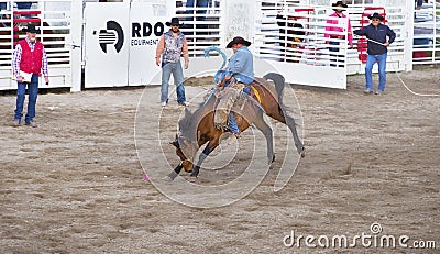 Cowboys competing in Ranch Bronc Riding Editorial Stock Photo