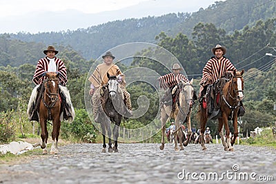 Cowboys in traditional wear riding on a country road Editorial Stock Photo