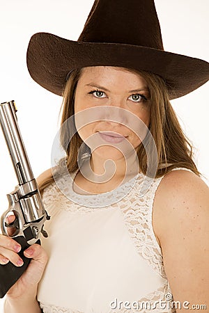 Cowgirl holding revolver with a smirk on her face Stock Photo