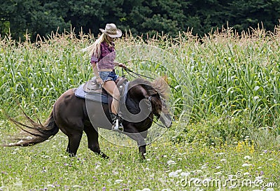 Cowgirl on a horse Stock Photo