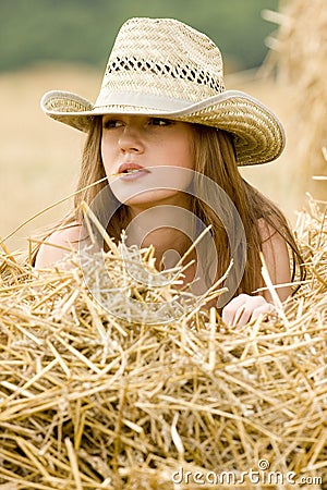 Cowgirl in straw Stock Photo