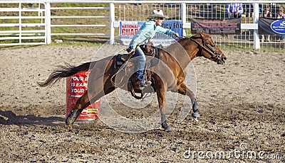 Cowgirls competing in barrel riding Editorial Stock Photo