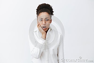 Coworker came work in blood, woman being stunned and shook. Portrait of shocked intense african-american female employer Stock Photo