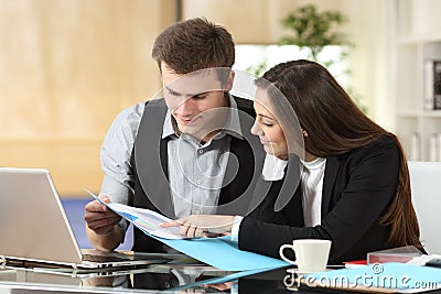 Coworkers checking informs together at office Stock Photo