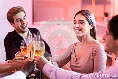 Coworkers Clinking Glasses During Christmas Celebratory Corporate Dinner In Restaurant Stock Photo