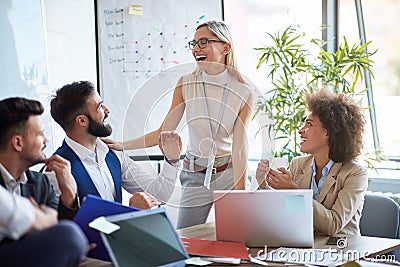 Coworkers laughing and joking around Stock Photo