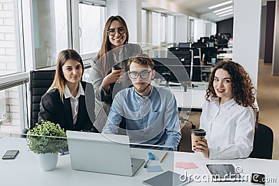 Coworkers looking at a computer and talking about work Stock Photo