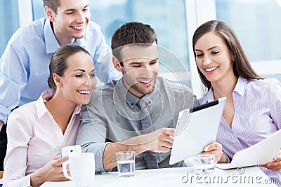 Coworkers looking at digital tablet Stock Photo