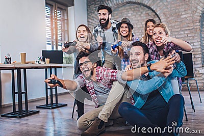 Coworkers playing video games Stock Photo