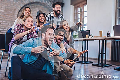 Coworkers playing video games Stock Photo