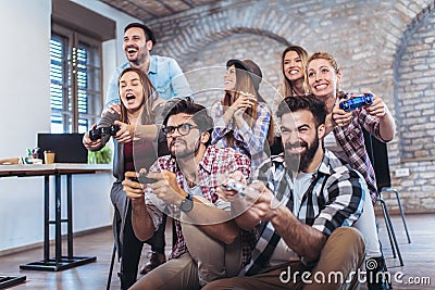 Coworkers playing video games Stock Photo