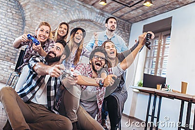 Coworkers playing video games in office. Stock Photo