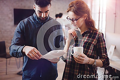 Coworking colleagues having conversation at workplace Stock Photo