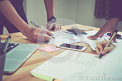 Coworking space, team working together. Modern workplace desks and computers and documents. Stock Photo