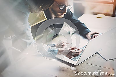 Coworking team meeting. Photo young businessmans crew working with new startup project in modern loft. Contemporary laptop wood ta Stock Photo