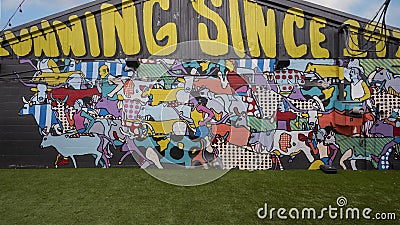 `Cowtown Mural`, an enamel mural by Katie Murray in the Foundry District`s Inspirational Alley in Fort Worth, Texas. Editorial Stock Photo