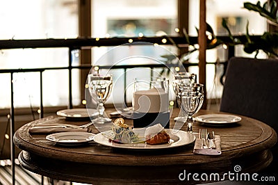 Cozy atmosphere at restaurant table with light snacks, cutlery and glasses Stock Photo