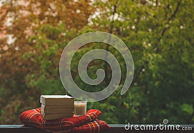 Cozy autumn still life: cup of hot coffee and opened book on vintage windowsill and rain outside. Autumn. Apartment. Rain Stock Photo