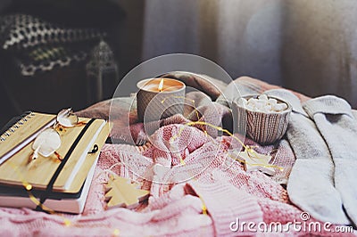 cozy autumn or winter morning at home. Still life details with cup of hot cocoa, candle, sketch book with herbarium and warm sweat Stock Photo