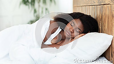 Young beautiful black woman sleeping in bed Stock Photo