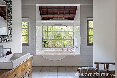 Cozy bright bathroom interior with built bathtub Stock Photo