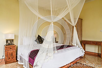 Cozy canopy bed in bedroom Stock Photo