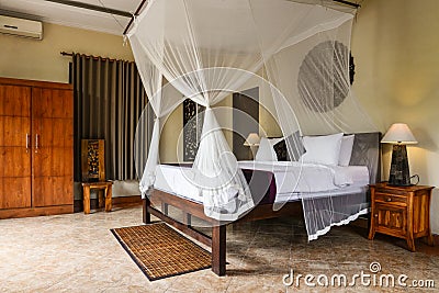 Cozy canopy bed in traditional balinese house Stock Photo