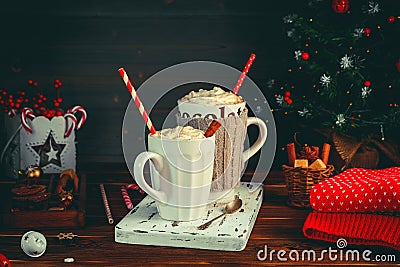 Cozy Christmas composition.Two mug with hot drinks, chocolate with whipped cream and cappuccino with cinnamon stick on a Stock Photo