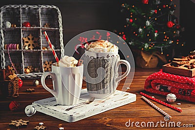 Cozy Christmas composition.Two mug with hot drinks, chocolate with whipped cream and cappuccino with cinnamon stick on a Stock Photo