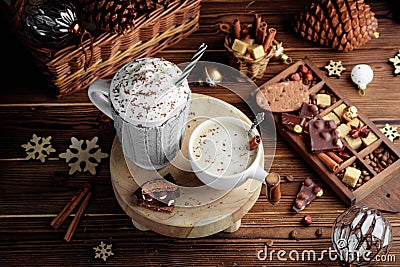 Cozy Christmas composition.Two mug with hot drinks, chocolate with whipped cream and cappuccino with cinnamon stick on a Stock Photo