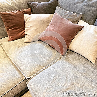 Cozy corner sofa with lots of cushions Stock Photo