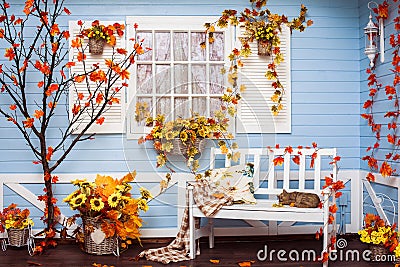 Cozy country house with blue walls and white window in autumn Stock Photo