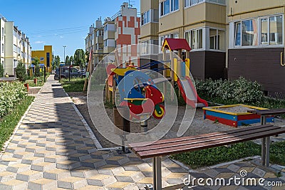 Cozy courtyard with green plants and attractions for children. A wonderful space for outdoor recreation among conifers Stock Photo