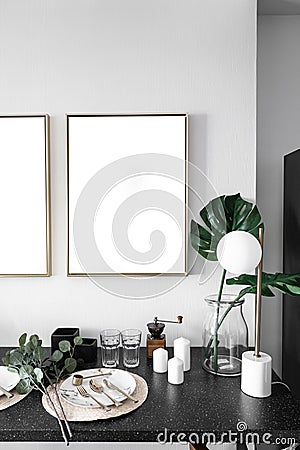 Cozy dining corner with nice decoration in scandinavian style with empty golden frame install on the wall / interior design decora Stock Photo