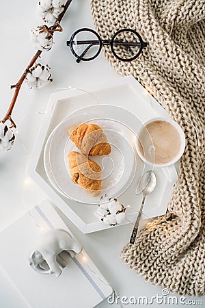 Cozy home breakfast, warm blanket, coffee and croissant on white Stock Photo
