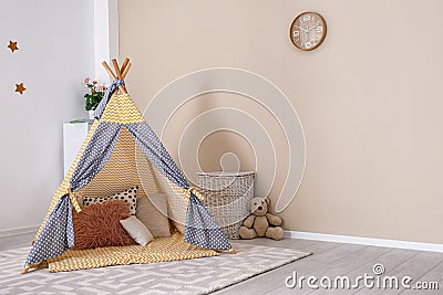 Cozy kids room interior with play tent and toys Stock Photo