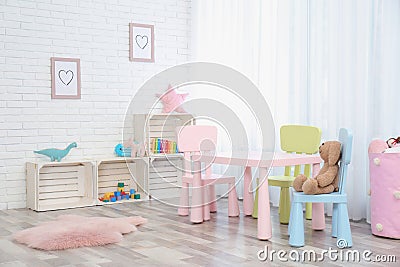 Cozy kids room interior with table, chairs Stock Photo