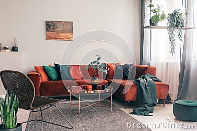 Cozy living room interior with corner sofa with pillows and painting on the wall Stock Photo