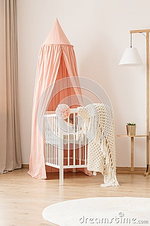 Crib and creative floor lamp Stock Photo