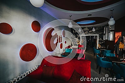 Cozy modern restaurant interior with comfortable soft chairs and beautiful wall decorations Editorial Stock Photo