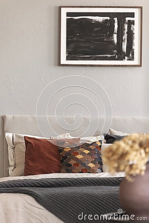 Cozy pillows on comfortable big king size bed in bright bedroom interior in elegant apartment Stock Photo