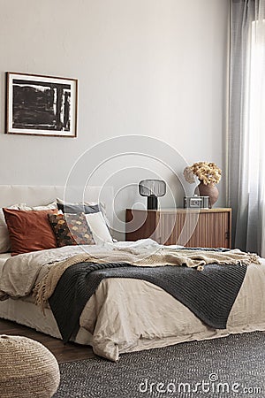 Cozy pillows on comfortable big king size bed in bright bedroom interior in elegant apartment Stock Photo