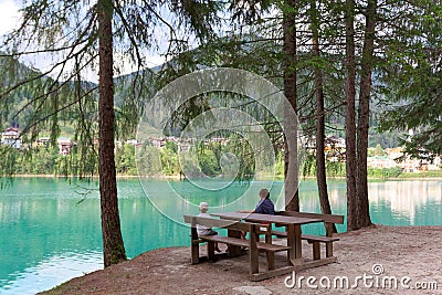 Cozy place. table and bench by the lake Editorial Stock Photo