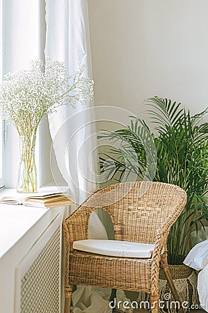 Cozy reading nook by the window with rattan wicker chair Stock Photo